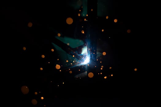 Metal welding. Sparks in dark. Welder's job. photo