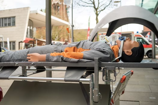 training emergency mannequin lies in a public place on the street photo