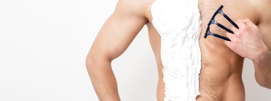 Young man shaving his chest photo