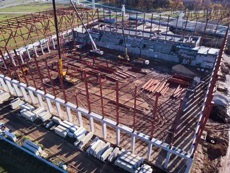 Unfinished metal frame of the building on a concrete base. photo