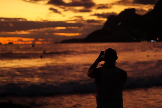 Rio de Janeiro, RJ, Brazil, 2022 - People in silhouette watch the sunset at Arpoador Rock, Ipanema Beach photo