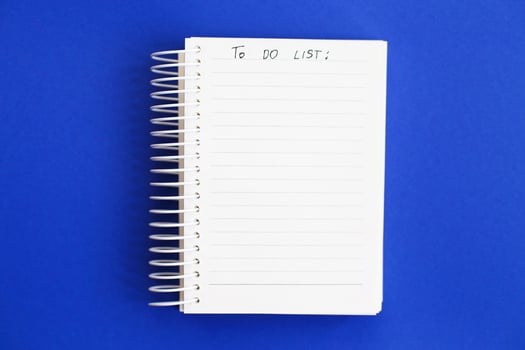 Top view of blank note paper on blue background. to do list photo