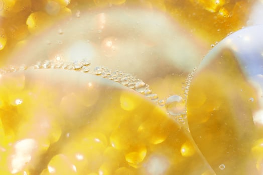 Gold Oil bubbles close up. circles of water macro. abstract shiny yellow background photo
