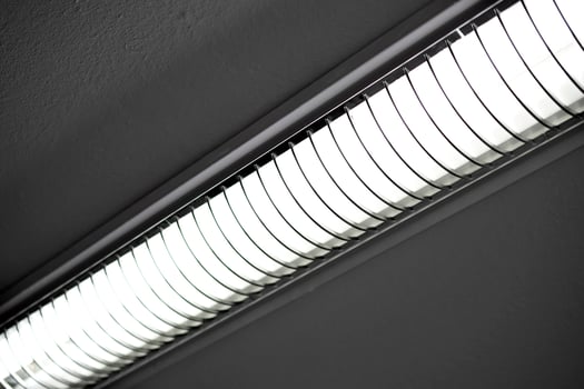 Fluorescent lamps on the whitewashed ceiling of the office space. A light lamp on the ceiling. photo