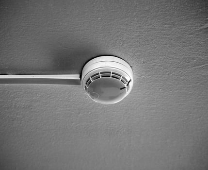A fire sensor on the ceiling. Fire protection system in the form of a white box. photo