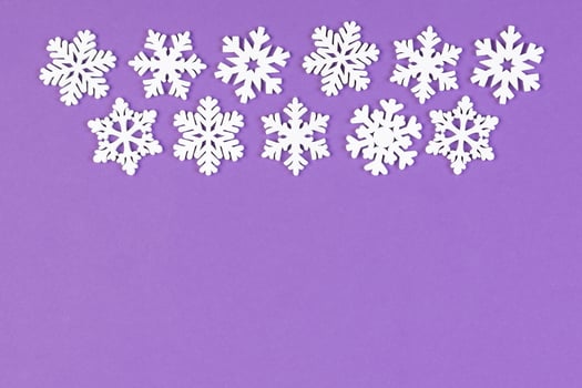 Set of white snowflakes on colorful background. Top view of Christmas ornament. New Year time concept with empty space for your design photo