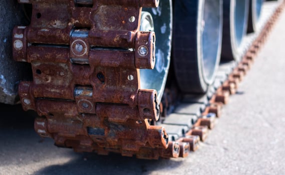 Rusty broken tracks with track rollers of a wrecked tank. Russian battle tank destroyed during the fighting during the Russian invasion of Ukraine, 2022. Remains of Russian military equipment. photo