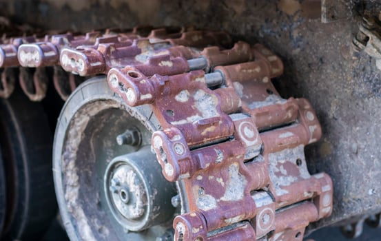 Rusty broken tracks with track rollers of a wrecked tank. Russian battle tank destroyed during the fighting during the Russian invasion of Ukraine, 2022. Remains of Russian military equipment. photo