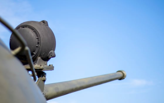 Tower of an armored personnel carrier or tank. Heavy weapons of war, sky background. Army equipment for combat and defense. Cannon tower. Details of military equipment. Close-up. photo