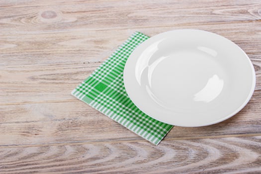 Empty plate and towel over wooden table background. View from above with copy space photo