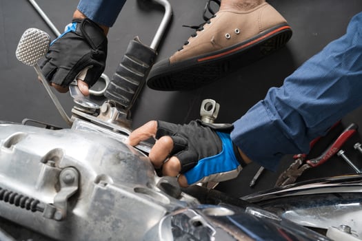 People are repairing a motorcycle Use a wrench and a screwdriver to work photo