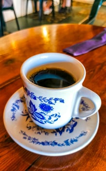 Blue white cup pot with black coffee wooden table Mexico. photo