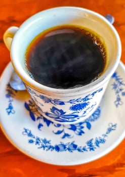 Blue white cup pot with black coffee wooden table Mexico. photo