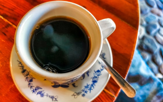 Blue white cup pot with black coffee wooden table Mexico. photo