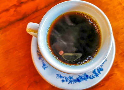 Blue white cup pot with black coffee wooden table Mexico. photo