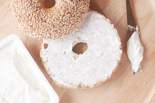 cheese cream spread on fresh bagel bread photo