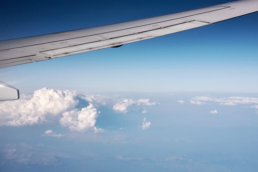 airplane wing and fluffy cloud, view from the airplane window photo