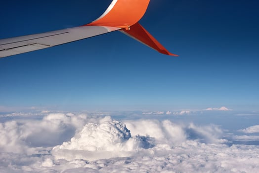 airplane wing and fluffy cloud, view from the airplane window photo