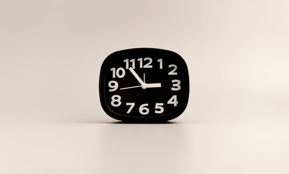 Black clock on gray background, time concept that matters to life and work. photo
