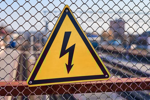 Electrical hazard sign. High voltage electricity on a railway station photo