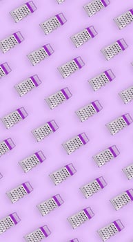 Small stainless steel graters lies on a pastel colored paper. Kitchen accessories. Tools for cooking. Flat lay top view photo