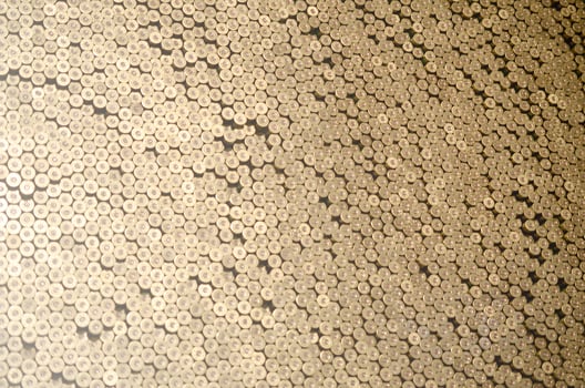 Pattern of 12 gauge cartridges for shotgun bullets. Shells for hunting rifle close up. Backdrop for shooting range or ammunition trade concepts photo