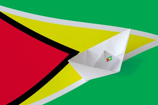 Guyana flag depicted on paper origami ship closeup. Handmade arts concept photo