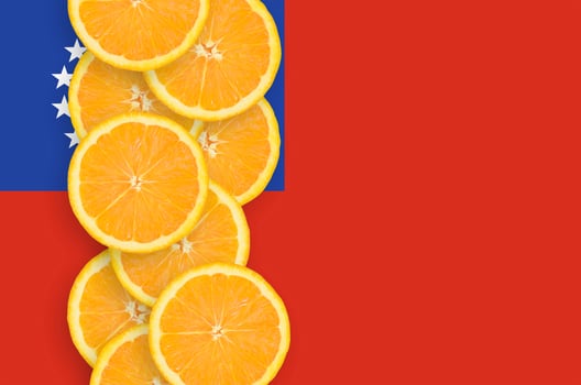 Myanmar flag and citrus fruit slices vertical row photo