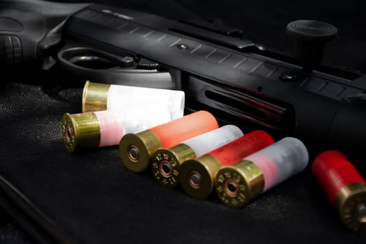 12 gauge red hunting cartridges for shotgun on wooden background. photo