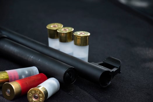 12 gauge red hunting cartridges for shotgun on wooden background. photo