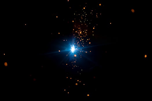 Welding work. Sparks from welding metal. Production details. photo