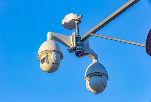 Security cctv cameras on pylon in blue background photo