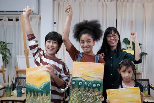 Group of art people in classroom studio, a teacher and student kids proud show painting work, an acrylic color picture on canvas, creative learning with talents skill at elementary school education. photo