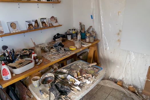 Artists workshop. Canvas, paint, brushes, palette knife lying on the table. photo