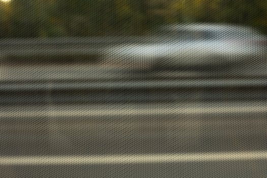 Texture of film on glass of bus. View through film to road. Blurred glass background. photo