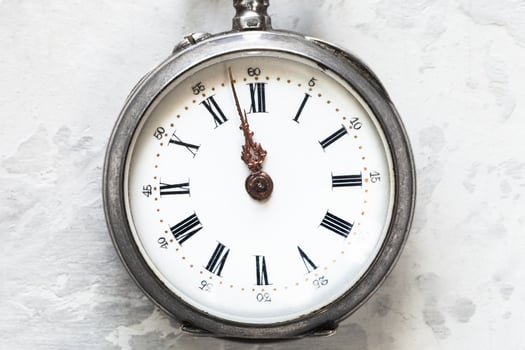 retro pocket watch on white concrete close up photo