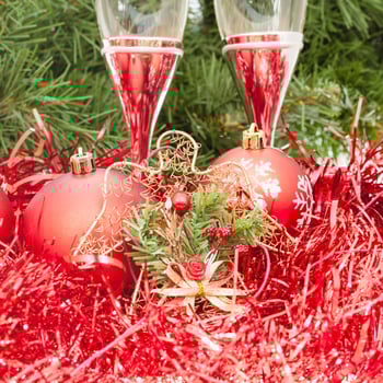 Two glasses with red Xmas decorations and tree 1 photo