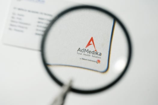 Admedika Card under magnifying glass with Selective Focus photo
