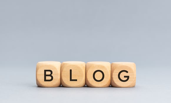 BLOG word on wooden cube blocks on gray background. Copy space photo