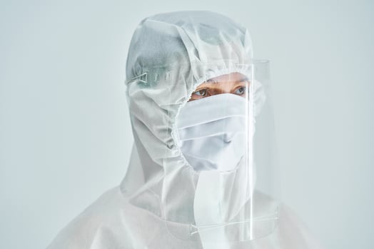 Woman in bio-hazard suit and face shield on white background. photo