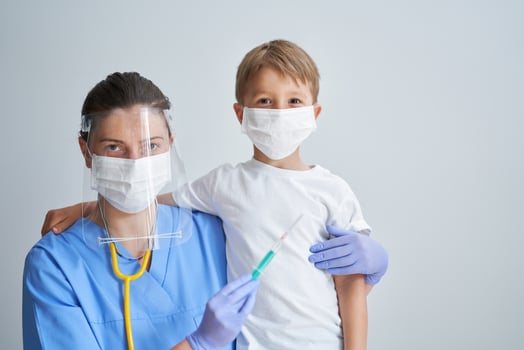 Portrait of adorable little boy being vaccinate at doctor's office photo