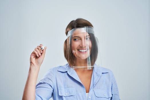 Attractive woman wearing protective shield writing over white background photo