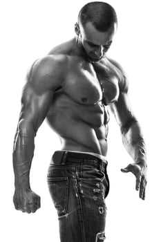 Handsome muscular man wearing jeans posing in studio photo