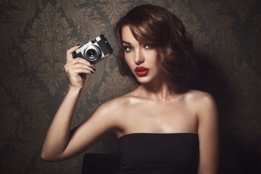 Beautiful woman with a vintage camera in hands photo