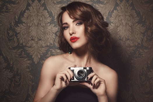 Beautiful woman with a vintage camera in hands photo