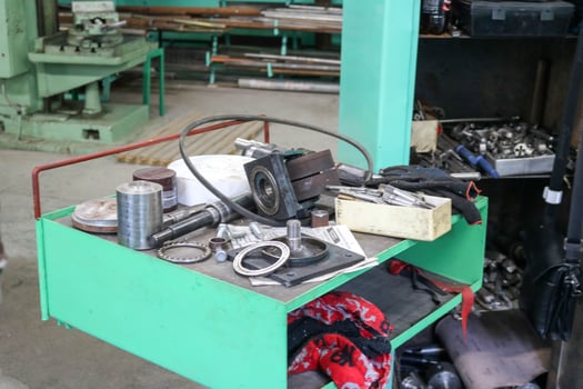 Spare parts, ring gaskets, bolts and tools on the table in the workshop at the metallurgical plant in the repair industry photo