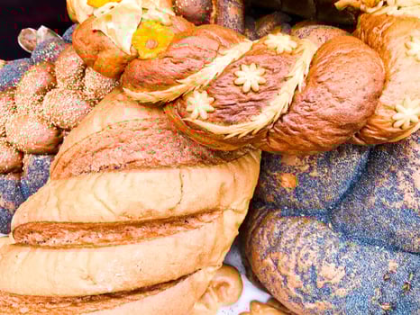 Texture of ruddy brown wheat lush tasty white loaves, bread, black poppy buns. The background photo