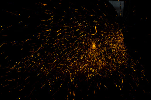 Lights in dark. Sparks from sawing metal. Industrial background. photo