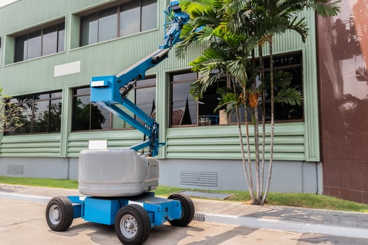 High-rise building maintenance engineers using cranes photo