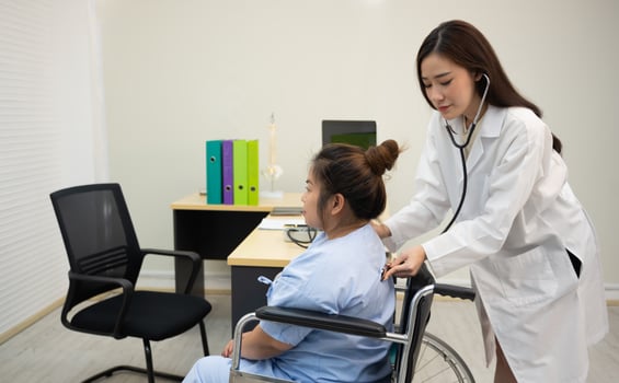 Doctors listen to patient back with a stethoscope for  internal sounds. photo